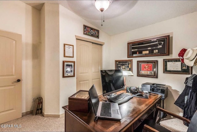 carpeted office space with vaulted ceiling