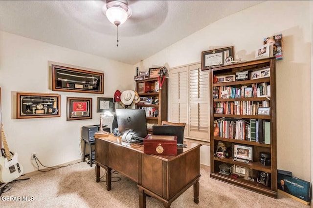 office space featuring lofted ceiling, light colored carpet, and ceiling fan