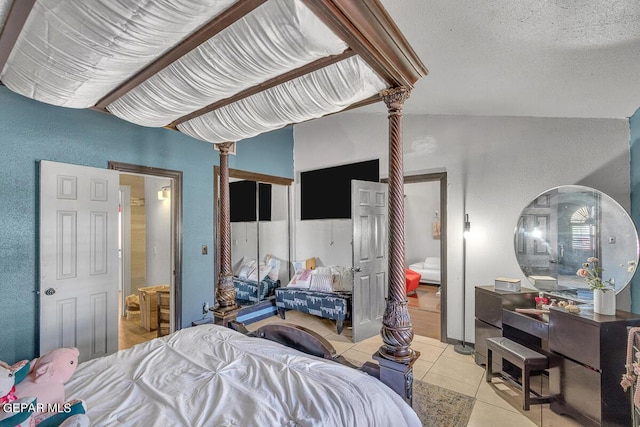 bedroom featuring a textured ceiling and light tile patterned floors