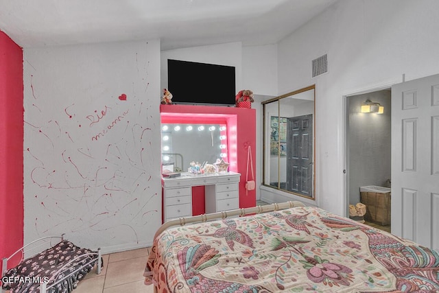 tiled bedroom with a closet