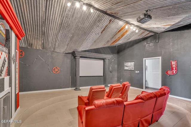 tiled home theater room with vaulted ceiling and wooden ceiling