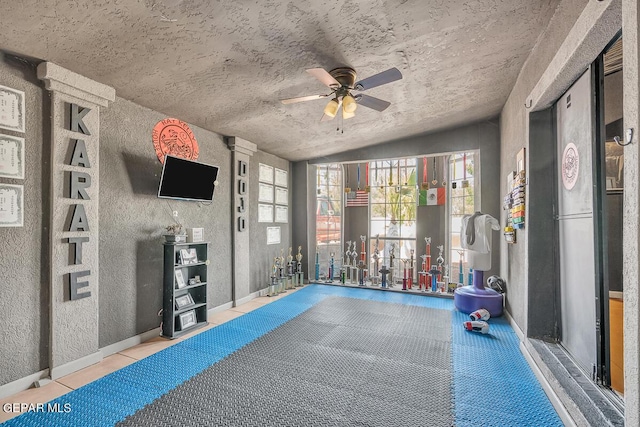 interior space with ceiling fan and light tile patterned flooring