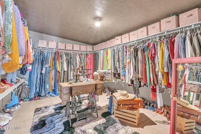 walk in closet with light tile patterned flooring