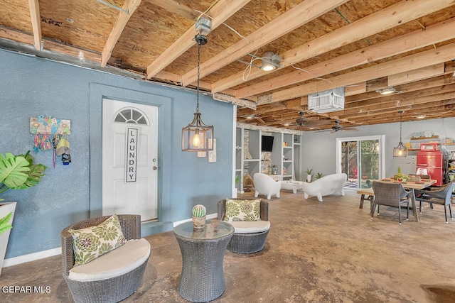 interior space featuring ceiling fan and concrete floors