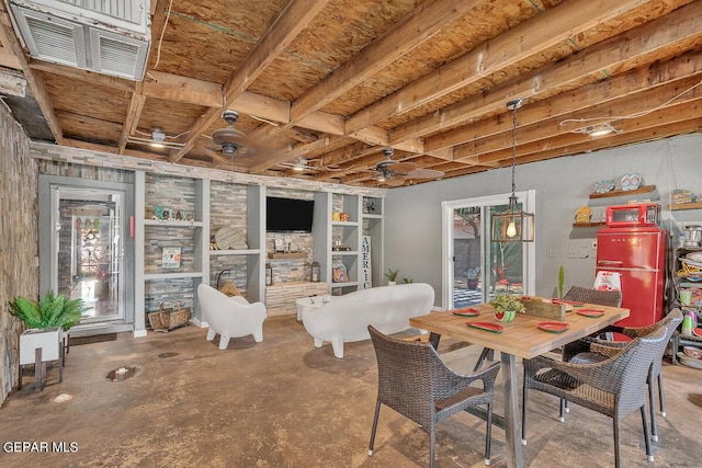 dining space featuring concrete floors and built in shelves