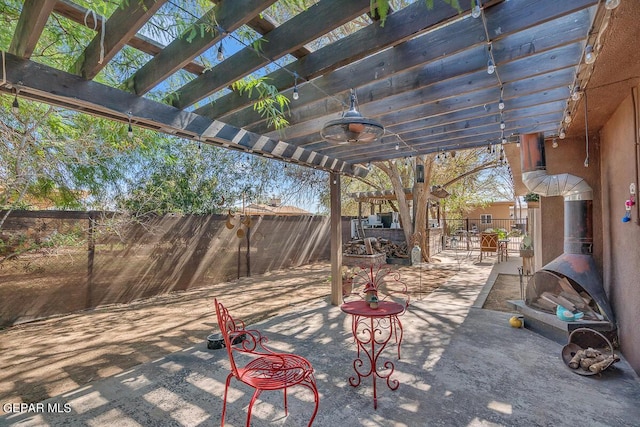 view of patio / terrace featuring ceiling fan and a pergola