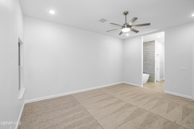 empty room with ceiling fan and light carpet