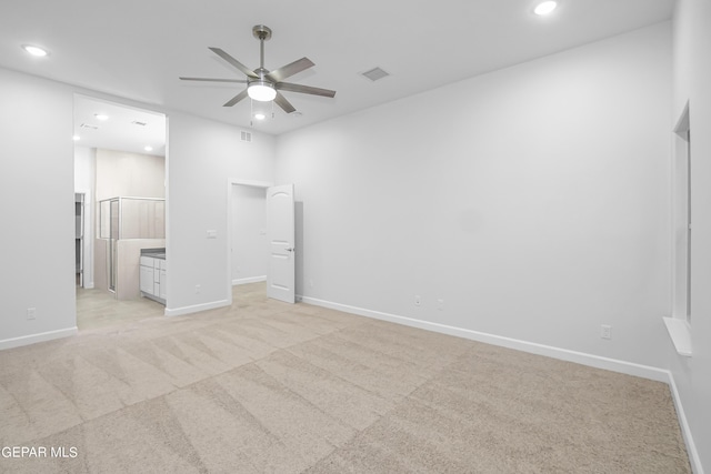 unfurnished bedroom with light carpet and connected bathroom