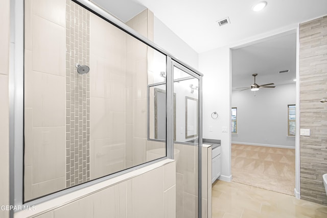 bathroom featuring a shower with door and ceiling fan