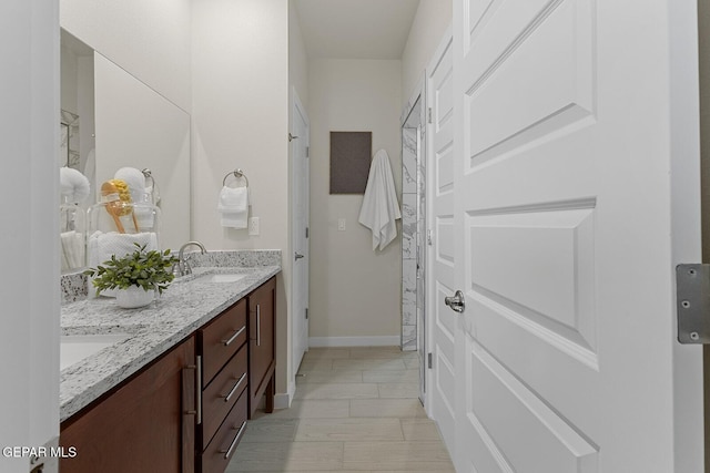 1022 Callie Ct, Socorro, TX 79927 - full bath with double vanity, baseboards, and a sink