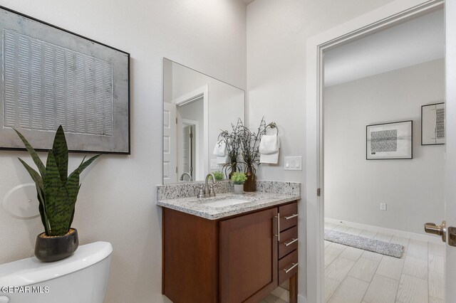 1022 Callie Ct, Socorro, TX 79927 - half bathroom with toilet, baseboards, and vanity