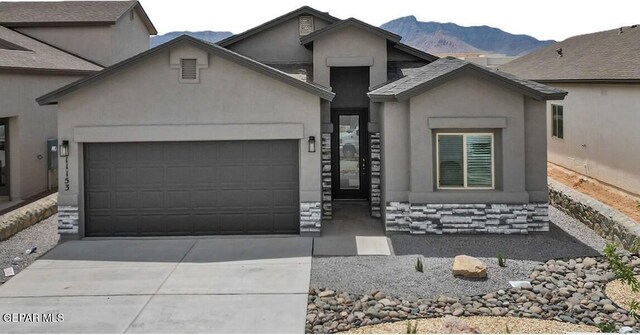 1022 Callie Ct, Socorro, TX 79927 - view of front of house featuring a garage, driveway, a mountain view, and stucco siding