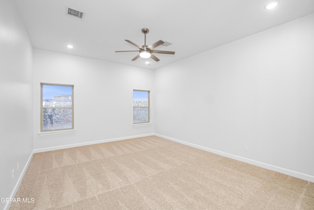 empty room featuring light colored carpet and ceiling fan