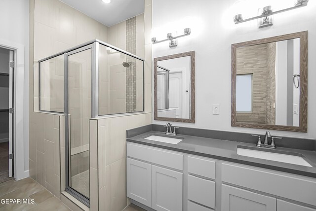 bathroom with vanity, tile patterned flooring, and a shower with shower door