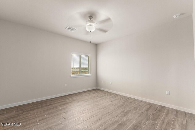 empty room featuring ceiling fan and light hardwood / wood-style floors