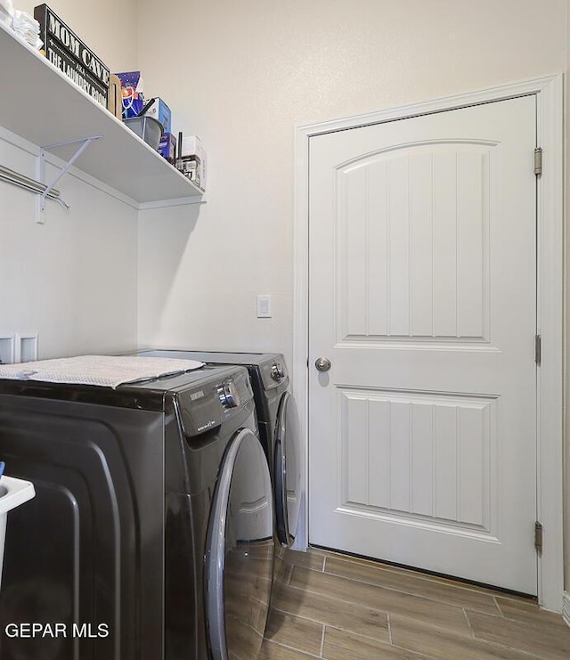 washroom with washing machine and clothes dryer