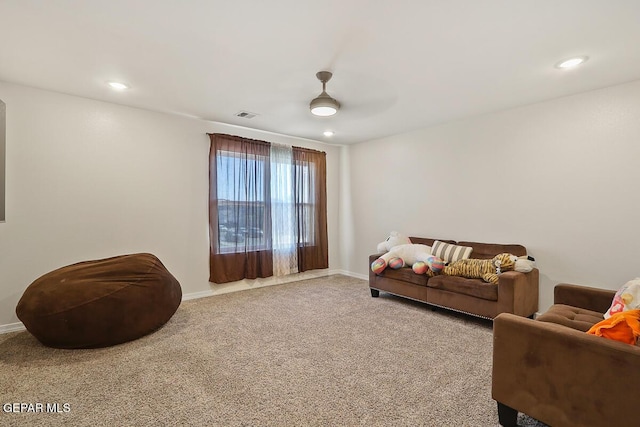 interior space with ceiling fan and carpet flooring