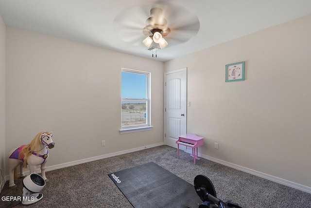 workout area with ceiling fan and carpet