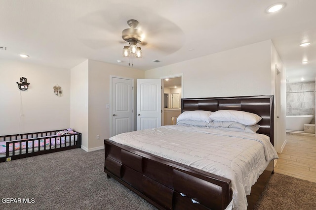 carpeted bedroom featuring ceiling fan and ensuite bath