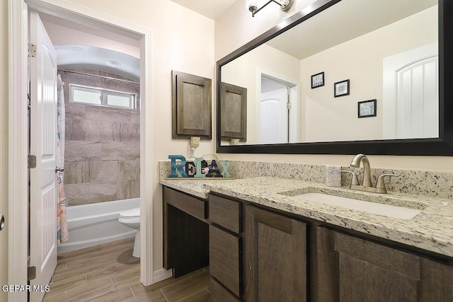 full bathroom with toilet, shower / tub combo, and vanity