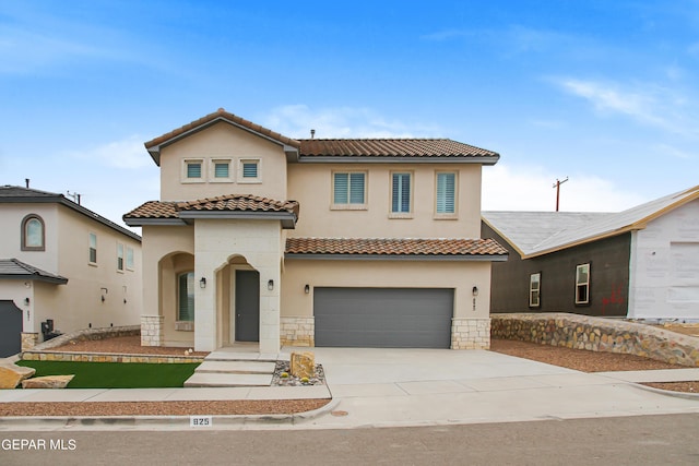 mediterranean / spanish-style home with a garage