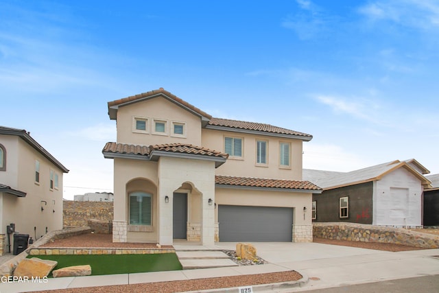 mediterranean / spanish-style home with a garage