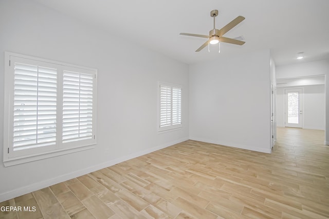 spare room featuring light hardwood / wood-style flooring and ceiling fan