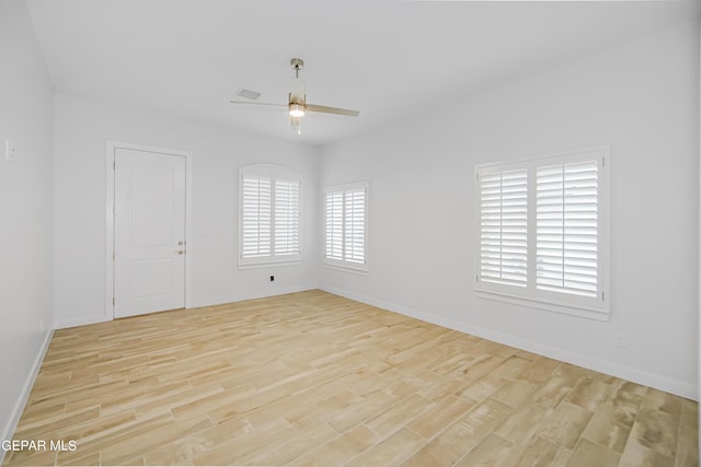 empty room featuring ceiling fan and light wood-type flooring