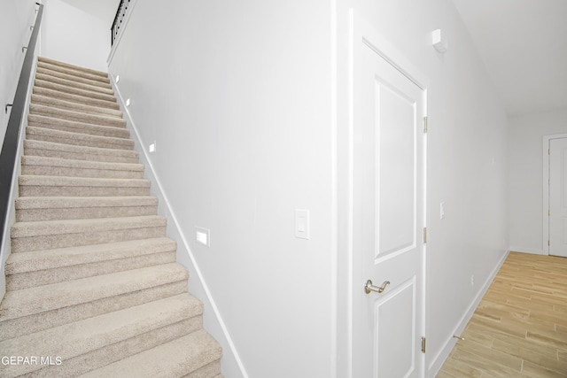 stairway with hardwood / wood-style flooring