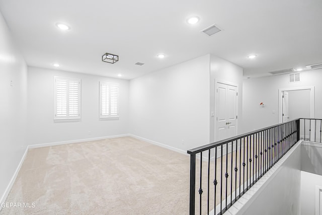 unfurnished room with light colored carpet