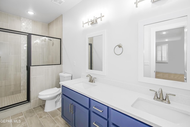 bathroom with walk in shower, vanity, and toilet