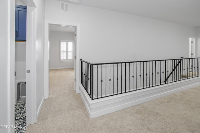 corridor with light colored carpet