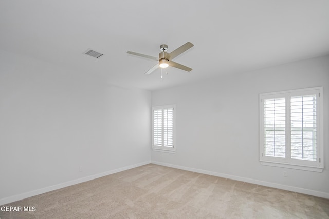 unfurnished room with ceiling fan and light colored carpet