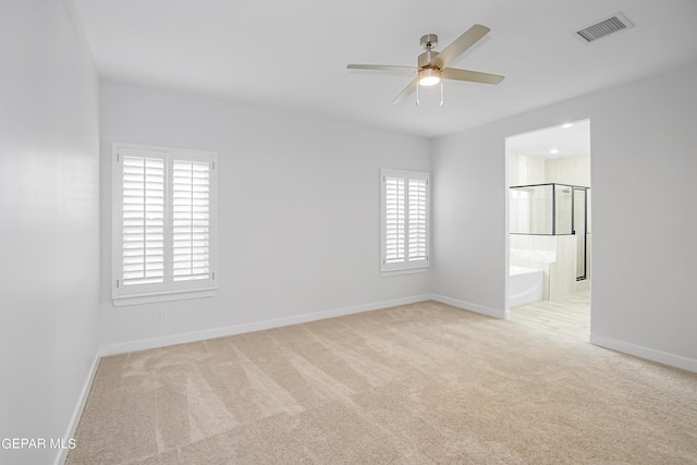 carpeted spare room featuring ceiling fan