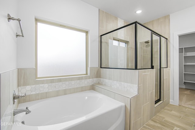 bathroom with hardwood / wood-style floors and plus walk in shower