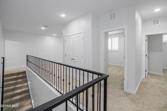 hall featuring light colored carpet