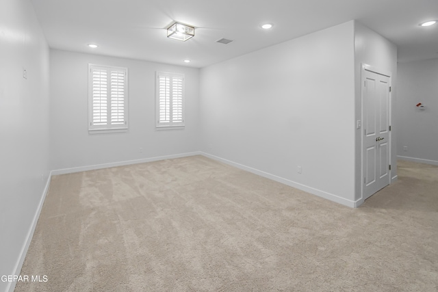 spare room with light colored carpet