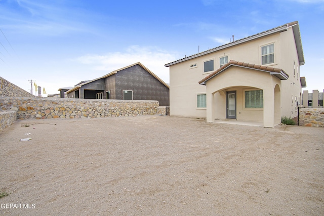 back of property featuring a patio