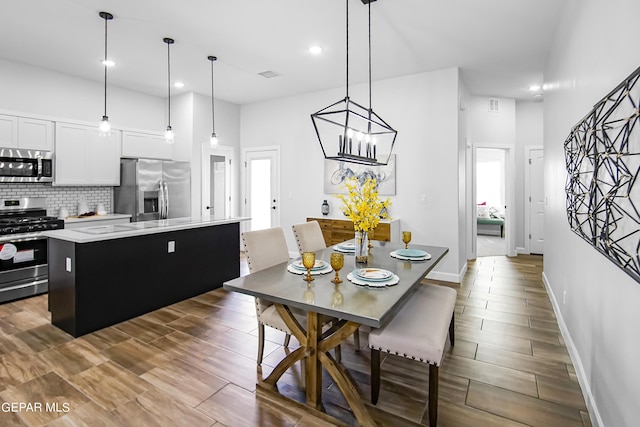 dining space with a towering ceiling and dark hardwood / wood-style flooring