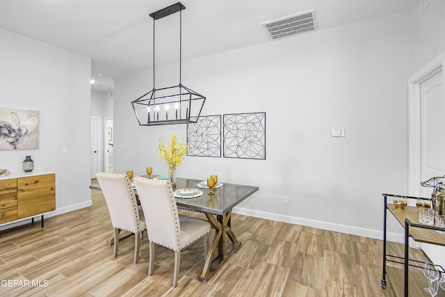 dining room featuring a chandelier and light hardwood / wood-style flooring