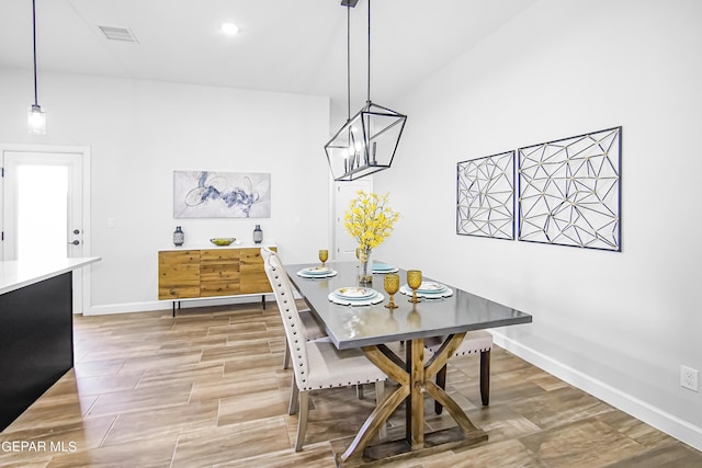 dining space with hardwood / wood-style flooring