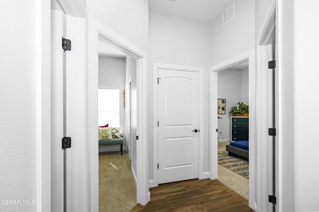 hallway with dark hardwood / wood-style flooring