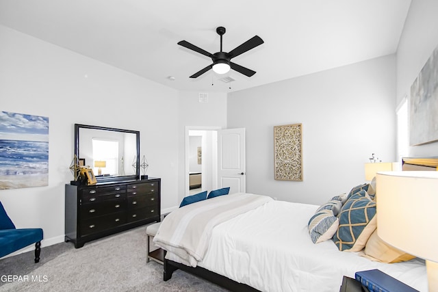 carpeted bedroom with multiple windows and ceiling fan