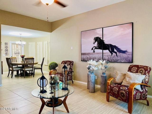 sitting room with light tile patterned flooring and a chandelier