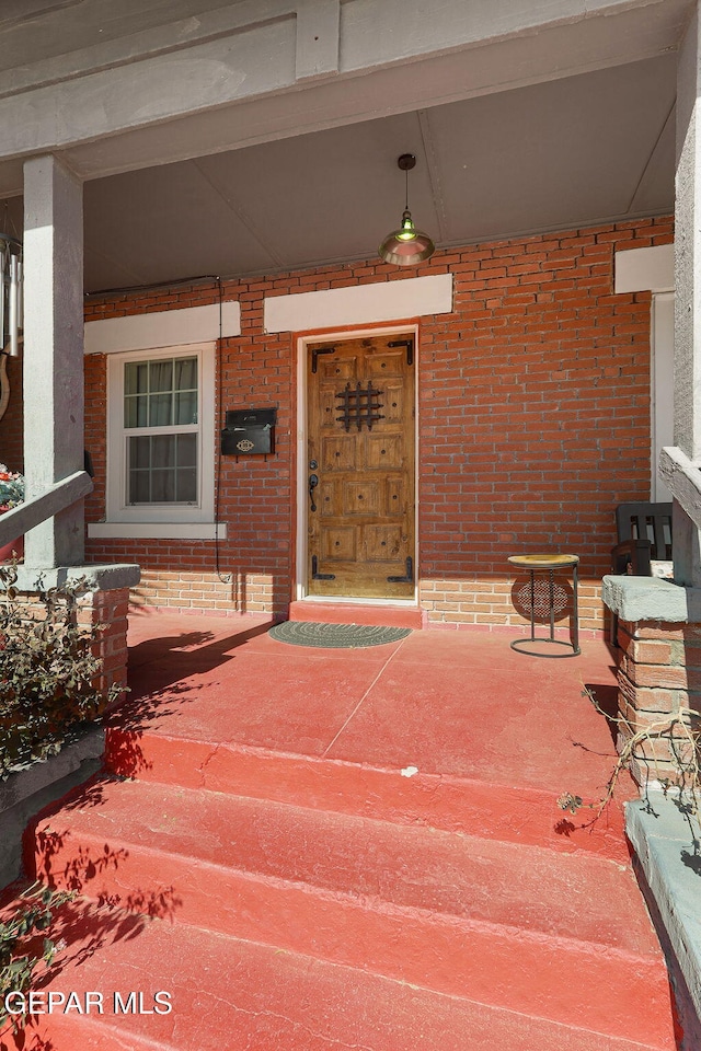 view of exterior entry with a porch