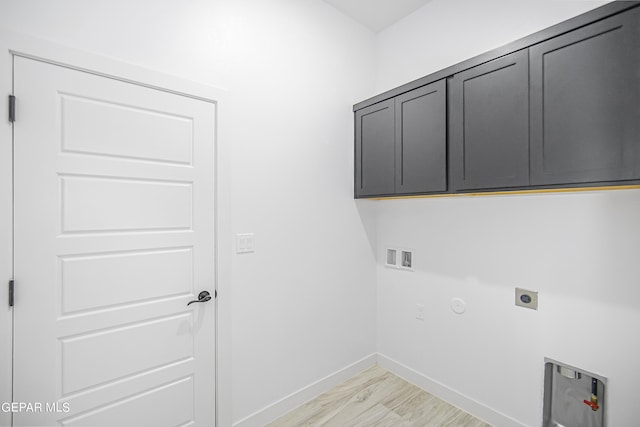 laundry area with gas dryer hookup, cabinets, washer hookup, hookup for an electric dryer, and light hardwood / wood-style floors