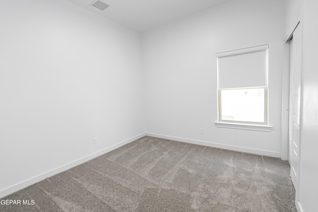 unfurnished room with light carpet