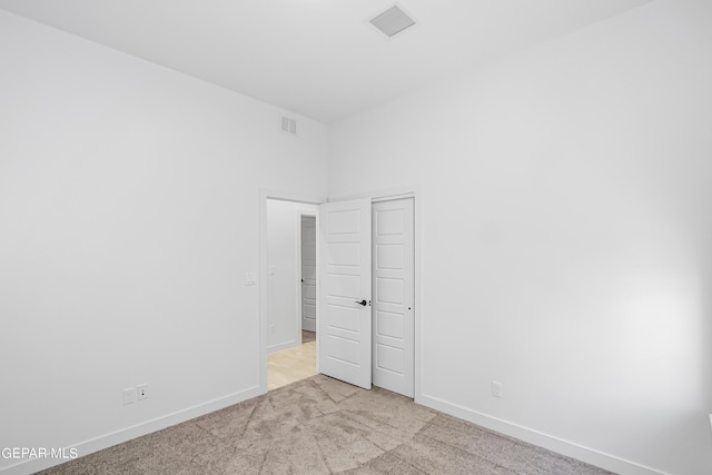 unfurnished bedroom featuring light carpet