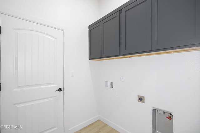 laundry room with cabinets, light hardwood / wood-style flooring, hookup for a washing machine, hookup for an electric dryer, and hookup for a gas dryer