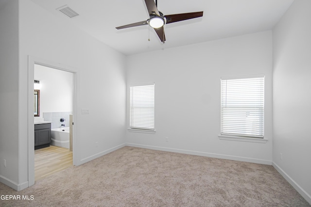 empty room with ceiling fan and light colored carpet